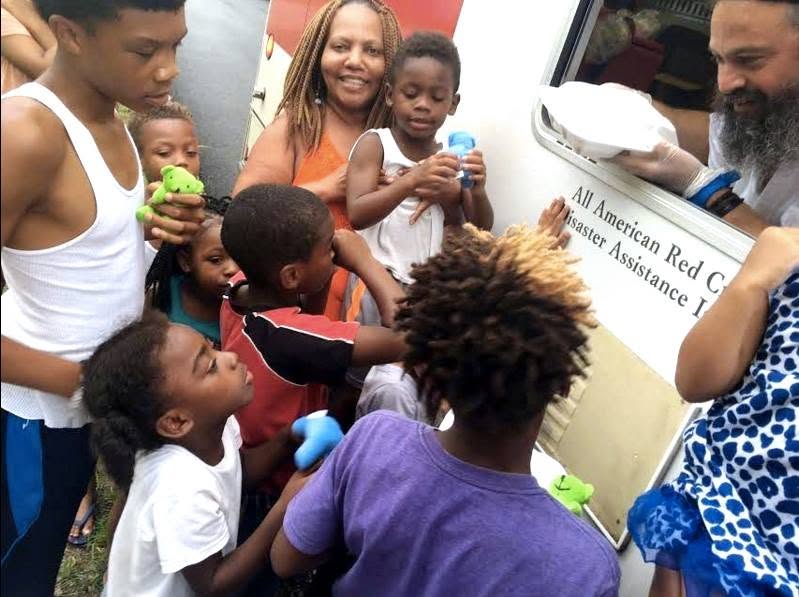 Rabbi Yossi handing hot meals from Red Cross truck in Baton Rouge
